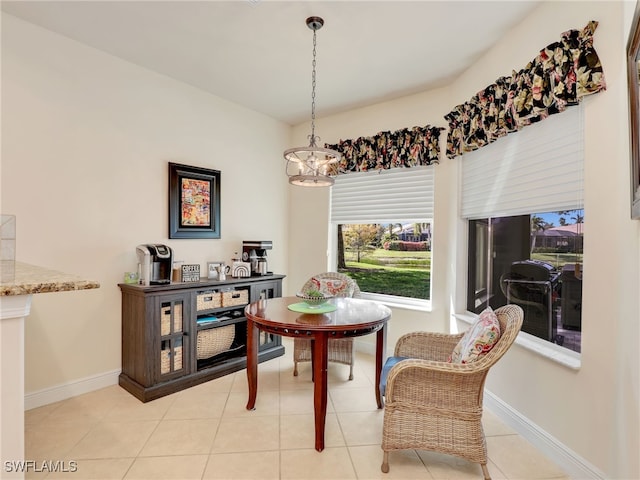 dining space featuring an inviting chandelier and light tile patterned flooring