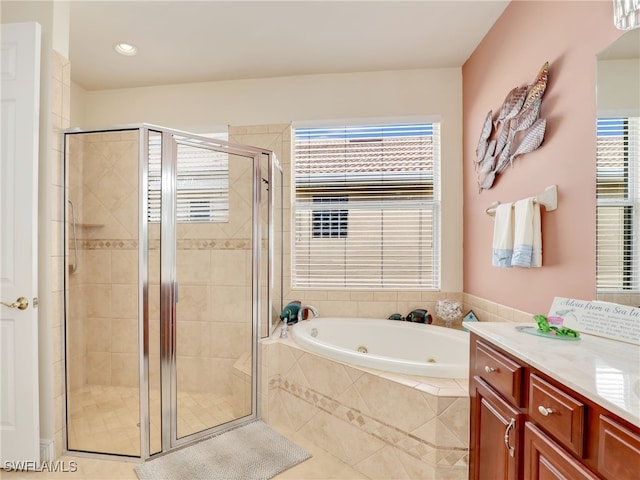 bathroom featuring vanity, tile patterned flooring, and separate shower and tub