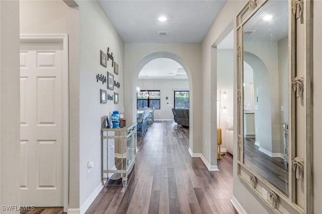 9368 Night Heron Ln, Naples, FL 34120 - hallway featuring arched walkways, dark wood-type flooring, baseboards, and recessed lighting