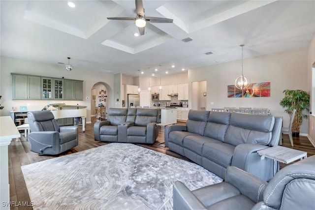 9368 Night Heron Ln, Naples, FL 34120 - living room featuring coffered ceiling, arched walkways, a ceiling fan, baseboards, and wood finished floors