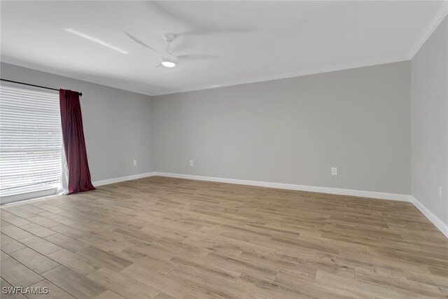 empty room featuring ceiling fan, crown molding, and light wood-type flooring