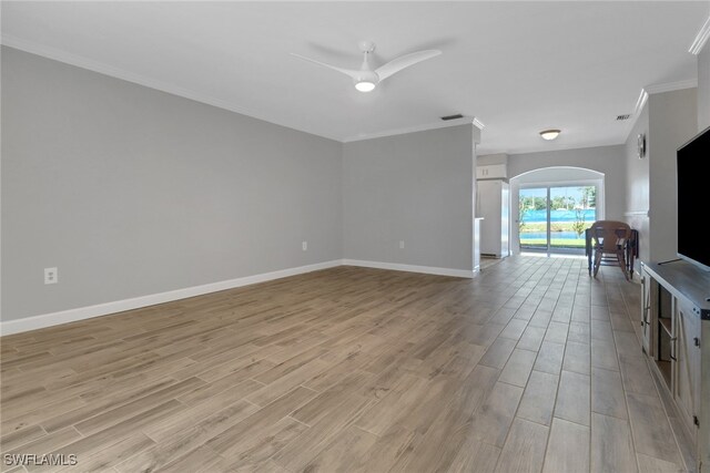 unfurnished living room featuring ornamental molding, ceiling fan, and light wood-type flooring