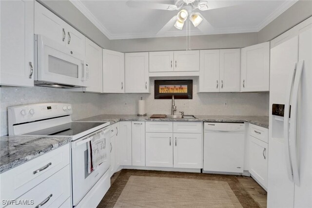 kitchen featuring sink, white appliances, crown molding, white cabinetry, and light stone countertops