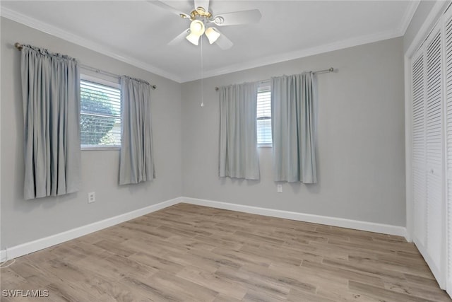 spare room with ornamental molding, ceiling fan, and light wood-type flooring