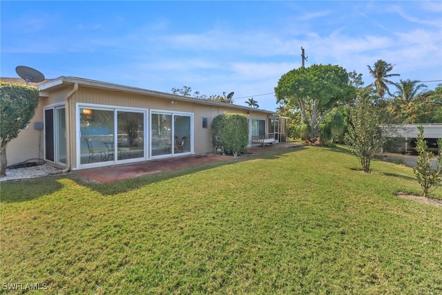 rear view of house with a lawn