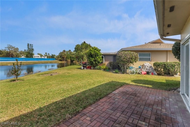 view of yard featuring a patio and a water view