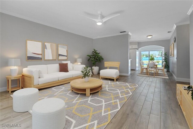 living room featuring ornamental molding and ceiling fan