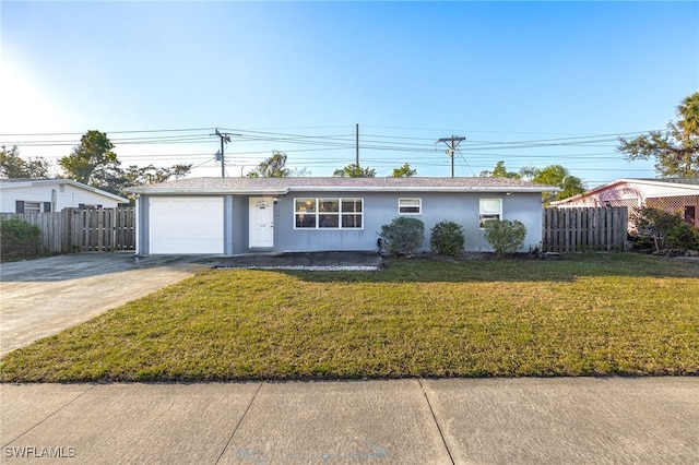 ranch-style home featuring a garage and a front lawn