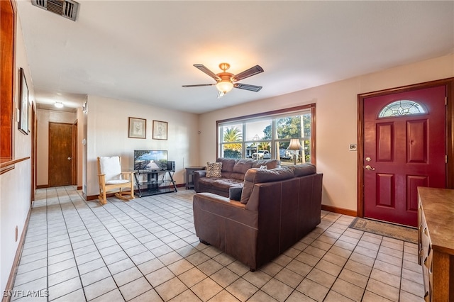 living room with ceiling fan and light tile patterned floors