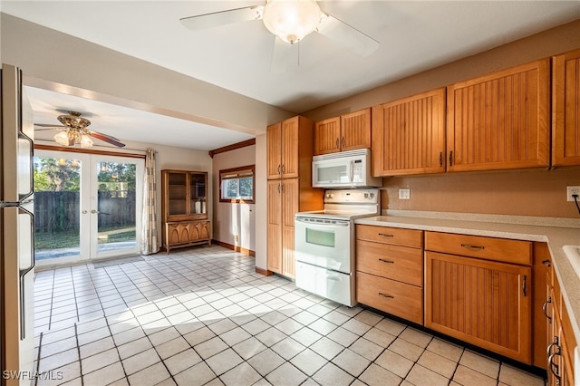 kitchen featuring ceiling fan, light tile patterned flooring, white appliances, and french doors