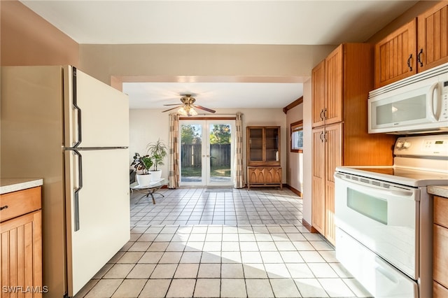 kitchen featuring light tile patterned floors, white appliances, french doors, and ceiling fan