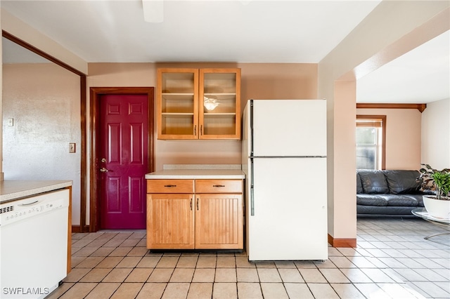 kitchen with light tile patterned flooring and white appliances