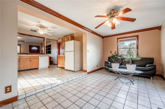 unfurnished living room with crown molding, sink, light tile patterned floors, and ceiling fan