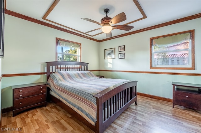 bedroom featuring crown molding, light hardwood / wood-style flooring, and ceiling fan