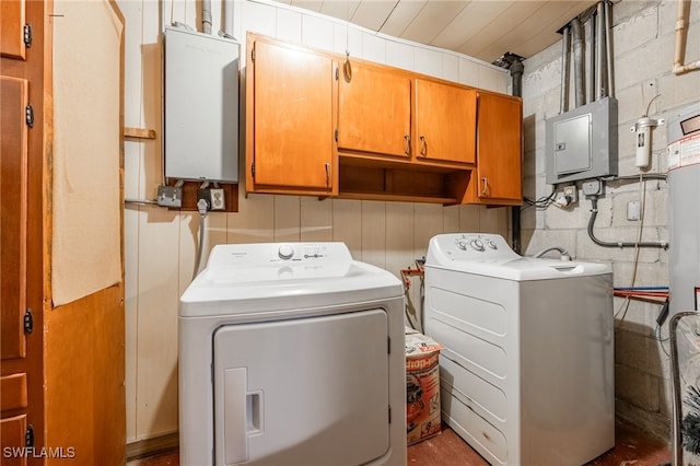 washroom with cabinets, electric panel, and washing machine and clothes dryer