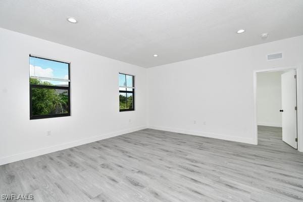 unfurnished room with light hardwood / wood-style flooring