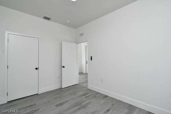 unfurnished bedroom with light wood-type flooring