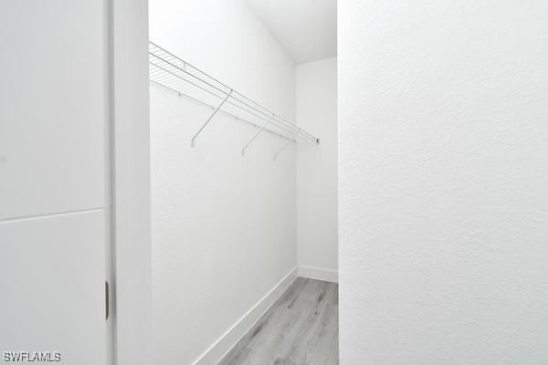 walk in closet featuring light hardwood / wood-style flooring