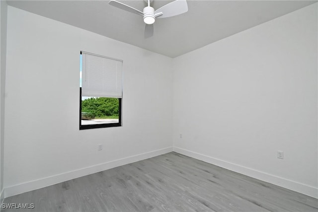 spare room with ceiling fan and light wood-type flooring