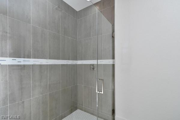 bathroom featuring a shower with door