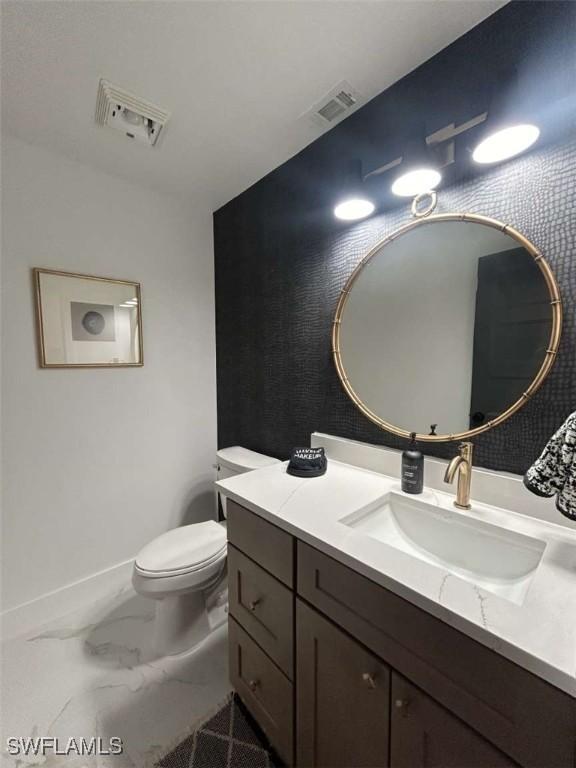 bathroom featuring vanity and toilet