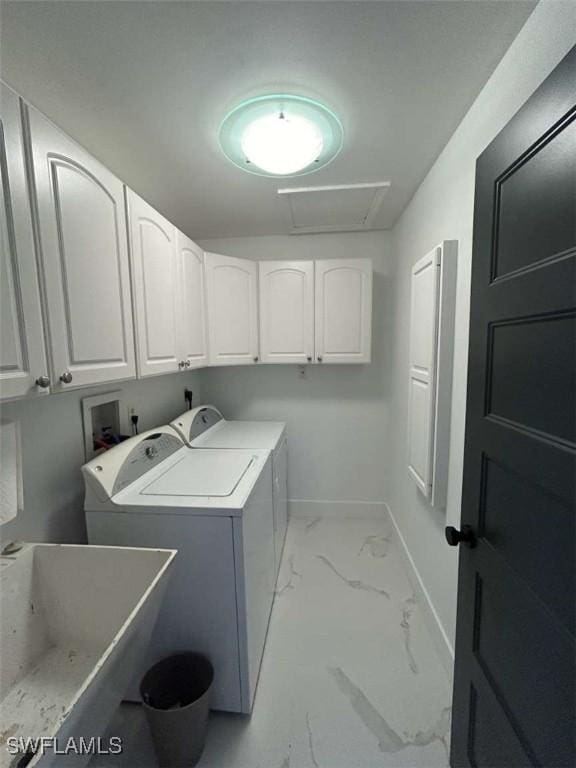 laundry area featuring independent washer and dryer, cabinets, and sink