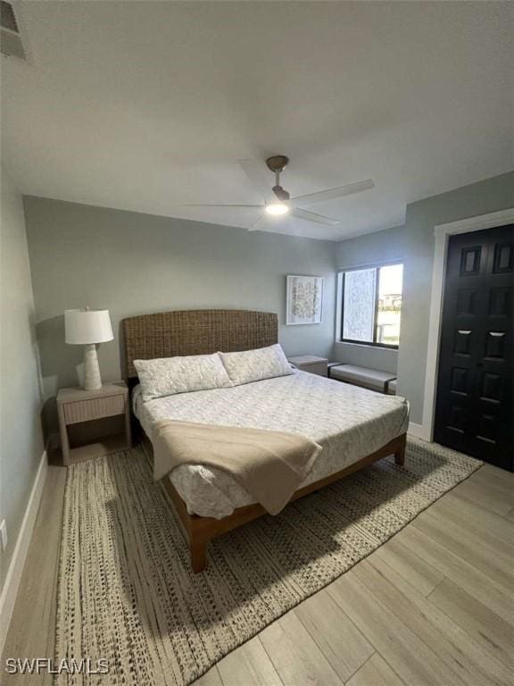 bedroom with ceiling fan and light wood-type flooring