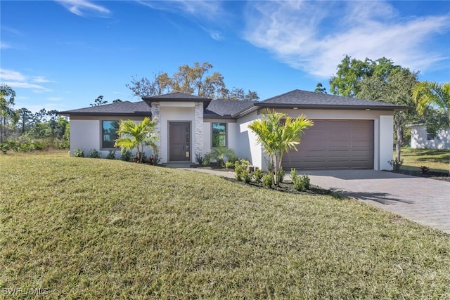 view of front of property featuring a garage and a front lawn