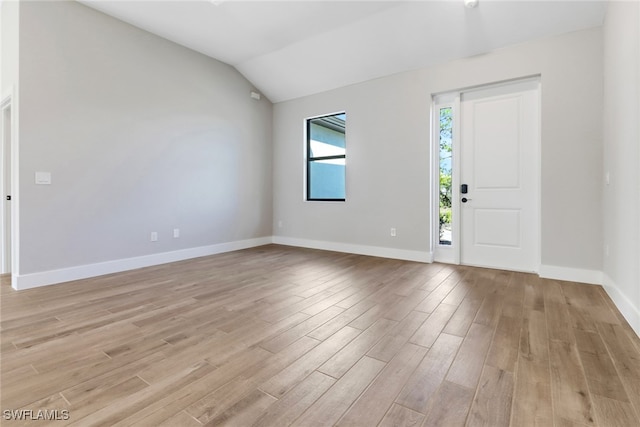 foyer with lofted ceiling and light wood-type flooring