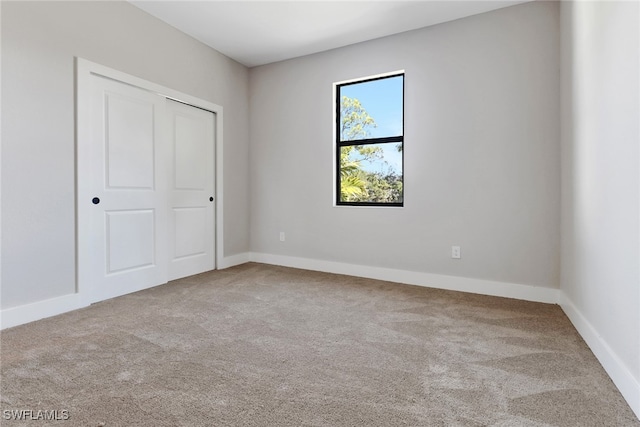 unfurnished bedroom featuring carpet and a closet