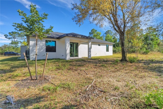 rear view of property with a yard