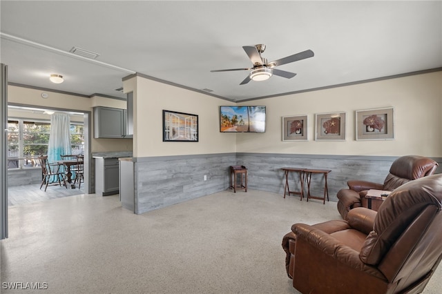 living room featuring ornamental molding and ceiling fan