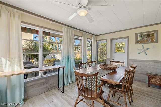 sunroom / solarium featuring ceiling fan and plenty of natural light