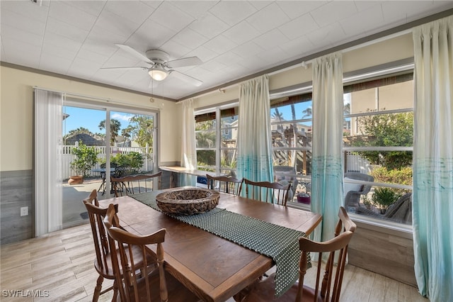 sunroom / solarium featuring ceiling fan