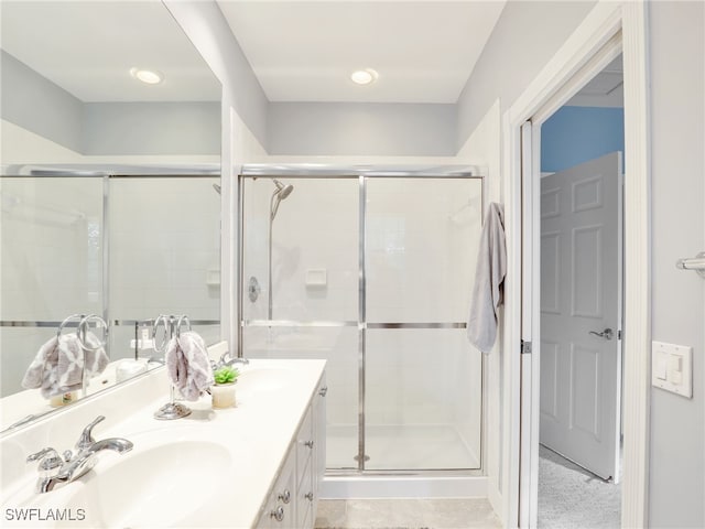 bathroom with vanity and a shower with shower door