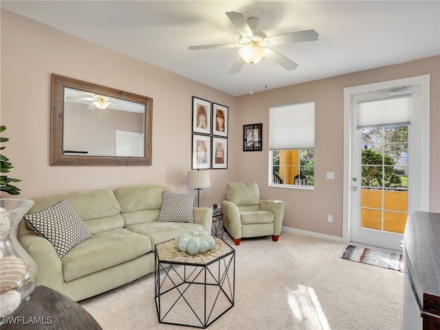 carpeted living room with ceiling fan