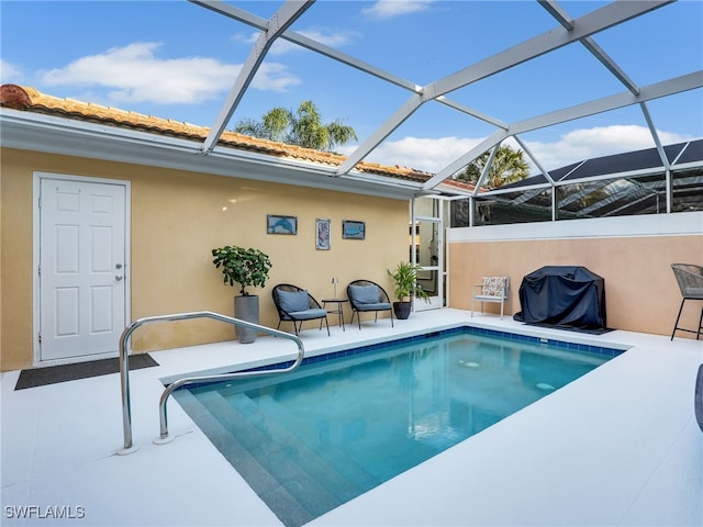 view of swimming pool with a lanai, grilling area, and a patio area