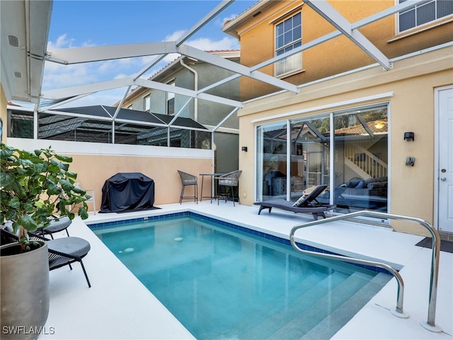 view of pool featuring area for grilling and a lanai