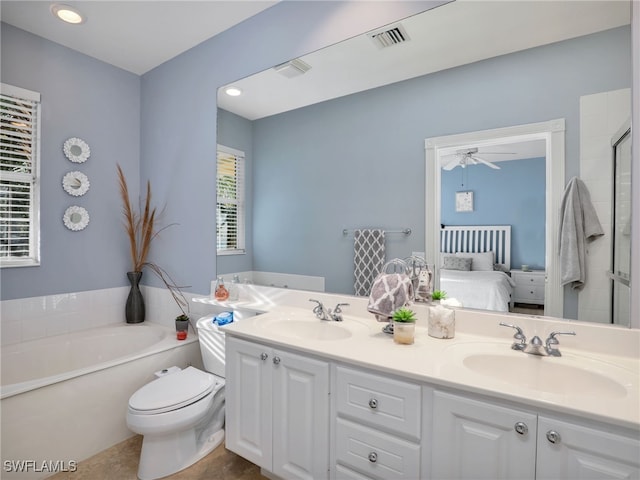 bathroom with vanity, ceiling fan, a washtub, and toilet