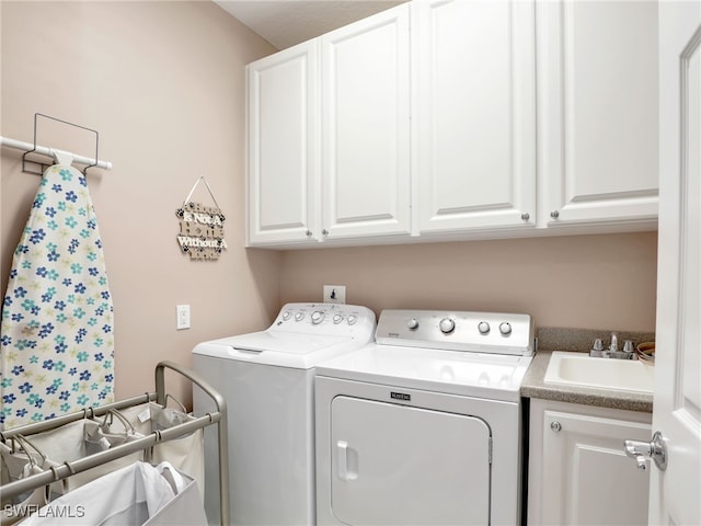 laundry room with cabinets, sink, and independent washer and dryer