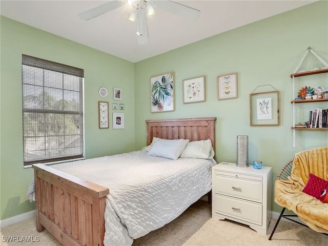 bedroom featuring light carpet and ceiling fan