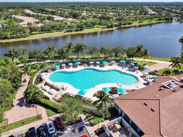 view of swimming pool with a water view and a patio area