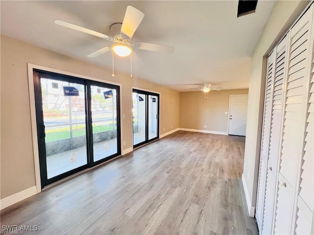 interior space with ceiling fan and light hardwood / wood-style floors