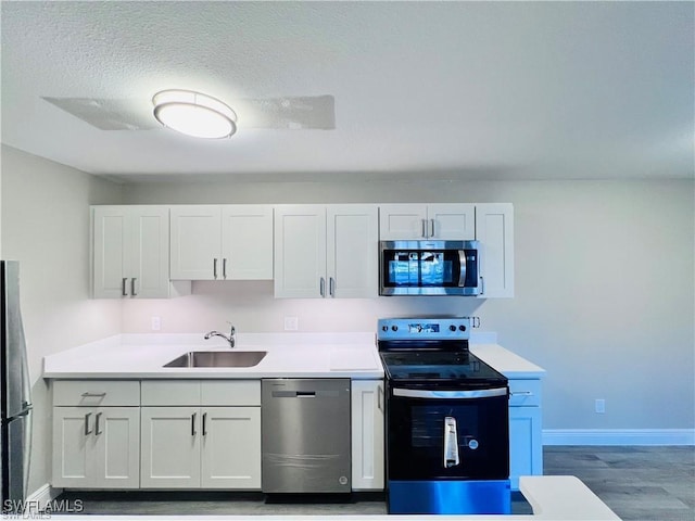 kitchen featuring white cabinetry, stainless steel appliances, and sink