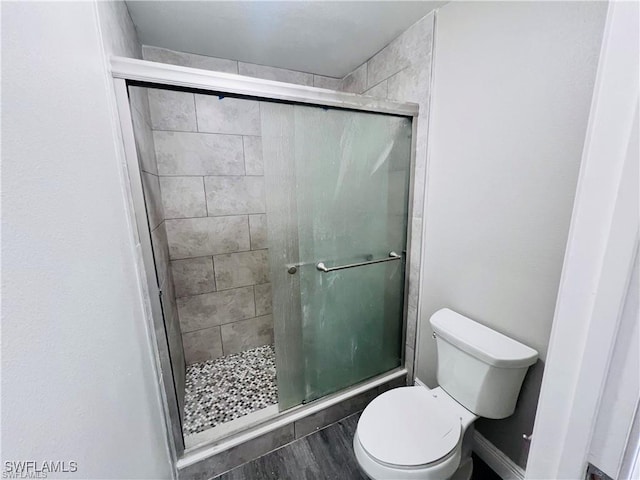 bathroom featuring toilet and walk in shower