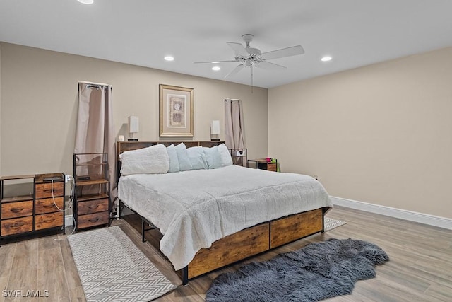 bedroom with ceiling fan and light wood-type flooring