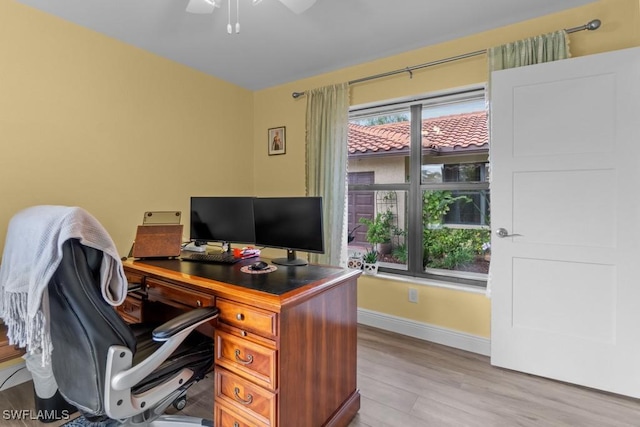 home office featuring light hardwood / wood-style flooring and ceiling fan