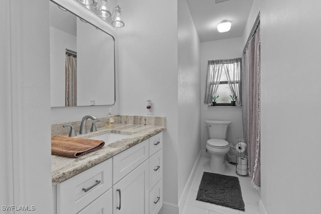 bathroom with vanity, tile patterned floors, and toilet