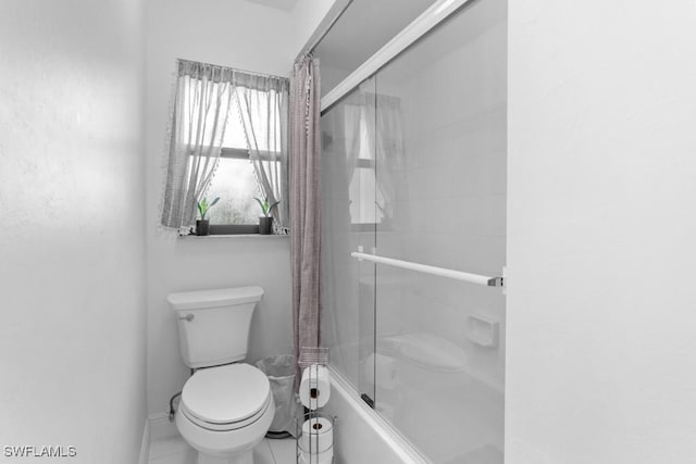 bathroom with enclosed tub / shower combo and toilet