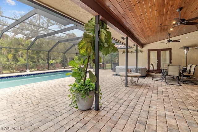 view of patio featuring a lanai and french doors